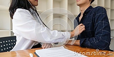 Close up of Doctor using stethoscope to exam heart and lungs of patient male Stock Photo