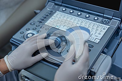 Close up of doctors hand on ultrasonography apparatus Stock Photo