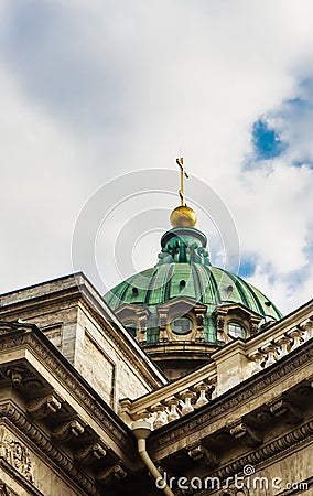 Close-up of the dome of the Kazan Cathedral with a golden cross part of a wall with columns and a frieze with windows, porticoes Stock Photo