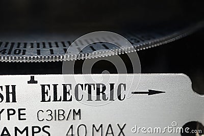 Close-up of a domestic kWh electric meter and slow turning measuring dial. Stock Photo
