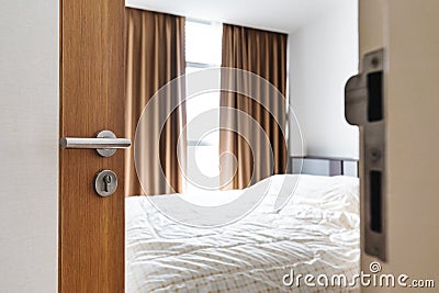 Close-up door opened, entering to bed room with bright sunlight from window in the morning Stock Photo