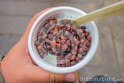 Close up Double skin milk or `shuang pi nai ` in chinese name top up with Red Bean on the top Stock Photo