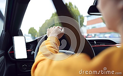 Close Up Of Driver With Hands Free Unit For Green Screen Mobile Phone Mounted On Dashboard Stock Photo
