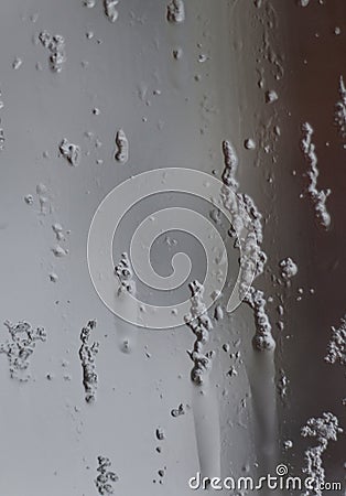 Close-up of a drop on the glass after rain and snow flowing down on a soft background. Stock Photo