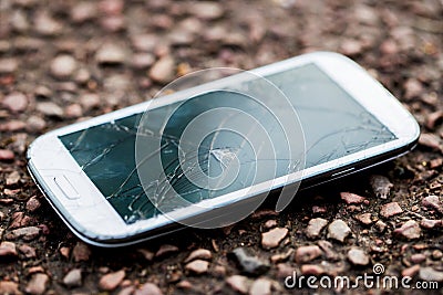 Close Up Of Dropped Mobile Phone With Cracked Screen Stock Photo