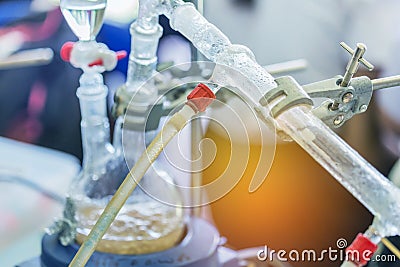 Close up dropping funnels of distillation set is separating the component substances from liquid mixture Stock Photo