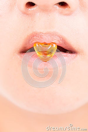 close up drug heart shape between lips Stock Photo