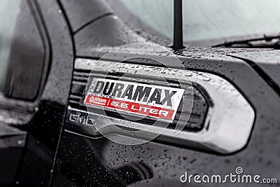 Close up of a Duramax trademark of a black 2020 GMC Sierra pickup truck covered in water drops Editorial Stock Photo