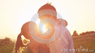 CLOSE UP: Easygoing young couple kisses in the rain on a picturesque evening. Stock Photo