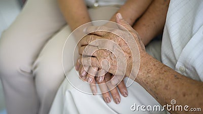 Close up of elderly hands holding each other , Grandfather hands is holding grandma hands , together , family concept Stock Photo
