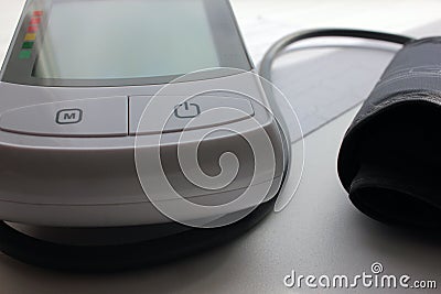 Close-up of electric digital device for measuring blood pressure Tonometer and cardiogram on a white background Stock Photo