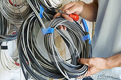 Close Up Of Electrician Fitting Wiring On Construction Site Stock Photo