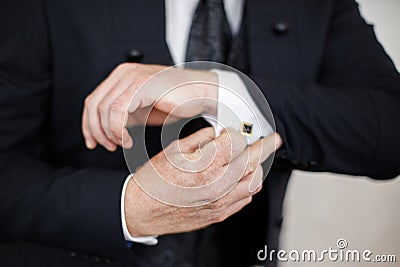 Close-up of elegance male hands wearing modern black suit Stock Photo