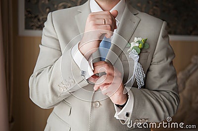 Close-up of elegance man hands with ring, necktie and cufflink Stock Photo