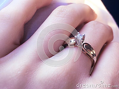 Close up of elegant diamond ring on the finger with gray Scarf background. Diamond ring. Stock Photo