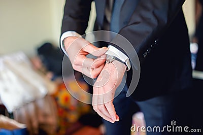 Close up of elegant man, groom hands with suits, ring, necktie Stock Photo