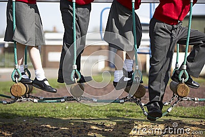 Close Up Of Elementary School Pupils On Climbing Equipment Stock Photo