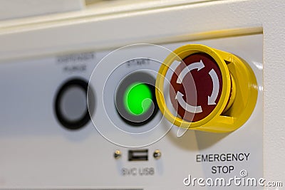 Close up emergency stop button on control panel of machine for safety at factory Stock Photo