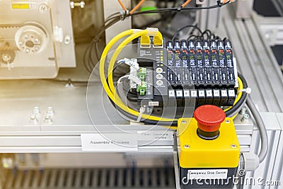 Close up emergency stop switch of high performance automatic programmable logic controller manufacturing assembly and inspection Stock Photo