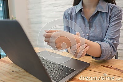 Close up employee woman massage on his hand and arm for relief p Stock Photo