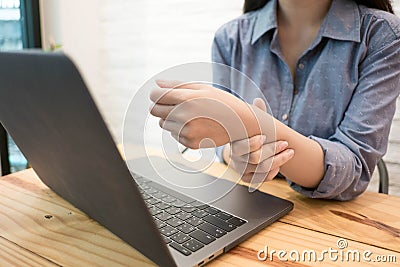 Close up employee woman massage on his hand and arm for relief pain from hard working..working woman concept Stock Photo