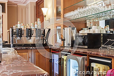 Close-up of empty vintage marble restaurant bar counter with coffee machine, microwave oven, glasses shelf Editorial Stock Photo