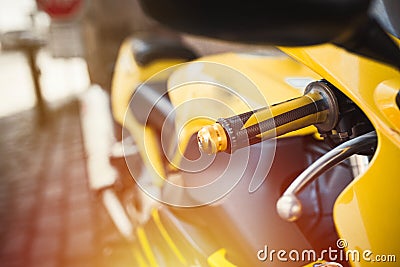 Close-up enduro metal shiny chrome handle and buttons brake and crutch part in selective focus . Yellow buggy fast race bike. Det Stock Photo