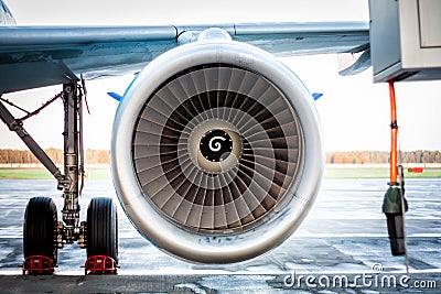 Close-up of engine and main landing gear of passenger airplane Stock Photo