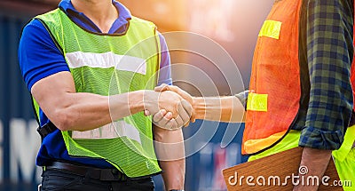 Close up of engineer and foreman worker handshake with blurred construction site, Success and Teamwork concept Stock Photo