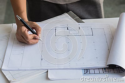 Close up of engineers hands working on table, he drawing project sketch in construction site or office. Stock Photo