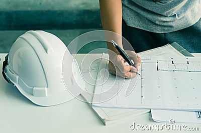 Close up of engineers hands working on table, he drawing project sketch in construction site or office Stock Photo