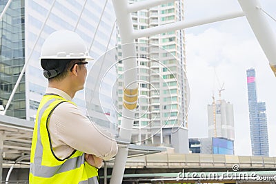 Close up engineers working on a building site holding a blueprints. Stock Photo