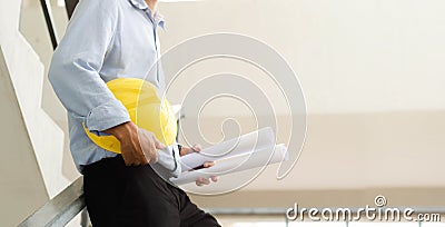 Close-up of engineers working on a construction site with blueprints, lighting, planning, engineering Stock Photo