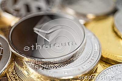 Close-up of ether physical coin on stack of many other cryptocurrencies Editorial Stock Photo