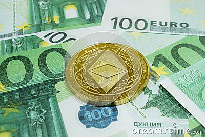 Close-up of Ethereum coins on 100 Euro banknotes. Crypto currency ETC Editorial Stock Photo