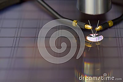 Close up of examining a sample of microchip transistor with probe station under the microscope in laboratory.A Stock Photo