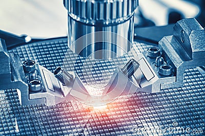Close up of examining of test sample of microchip transistor under the microscope in laboratory. Equipment for testing microchips. Stock Photo