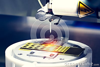 Close up of examining of test sample of microchip transistor under the microscope in laboratory. Equipment for testing microchips. Stock Photo