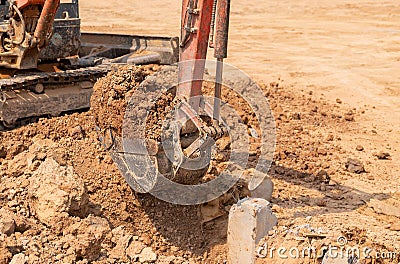 Close up excuvator digging a trench for foundation pile Stock Photo
