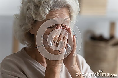 Close up exhausted mature woman suffering from eye strain Stock Photo