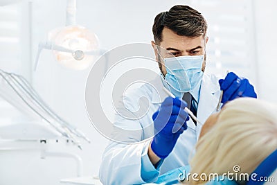 Close up of experienced stomatologist curing his patient Stock Photo