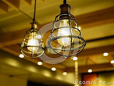 Close up of yellow light bulbs in metal cages Stock Photo