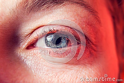 Close-up blue eye of a woman with a tear. People and emotions concept Stock Photo