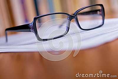 Close up Eyeglasses on Top of White Papers Stock Photo