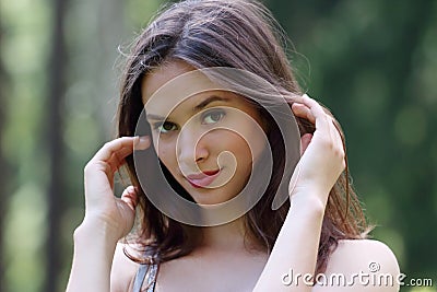 Close-up face of beautiful girl straightens her hair Stock Photo