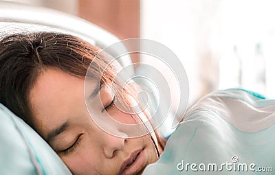 Close up face of beautiful illness asia patient women being sick and sleep in patient room affter treatment by doctor and Stock Photo