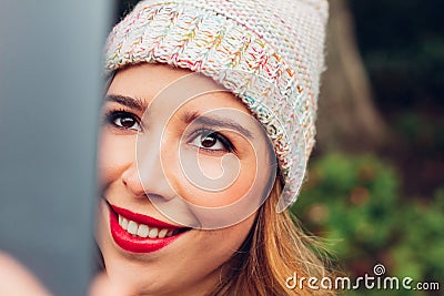 Close-up of the face of a beautiful young adult woman with blonde hair, taking a selfie with her digital tablet, with a natural, Stock Photo