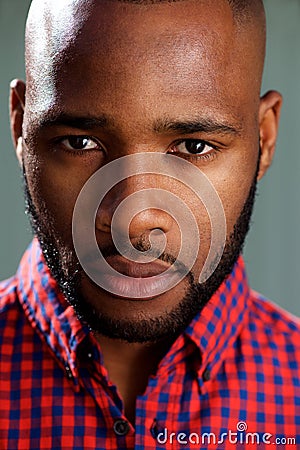 Close up face of handsome black guy against gray wall Stock Photo