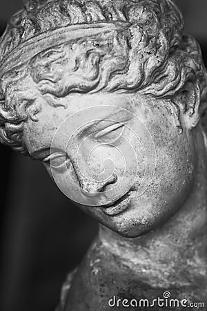 Close up face of Olympic goddess of love and beauty Aphrodite Venus. Fragment of ancient statue. Vertical image Stock Photo