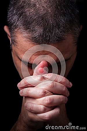 Close up of faithful mature man praying, hands folded in worship to god Stock Photo